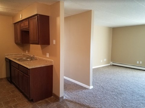 a empty room with a sink and a kitchen