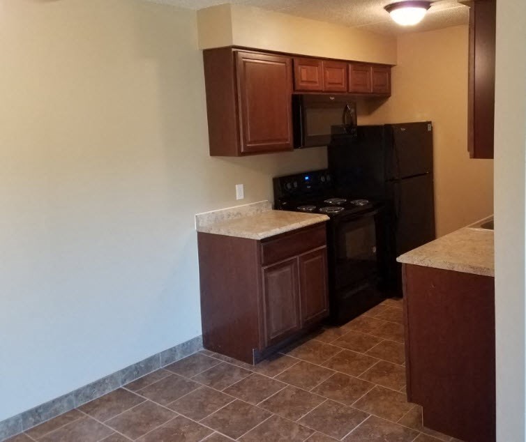 a kitchen with a stove and a refrigerator