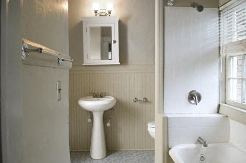 A white sink and toilet in a bathroom.