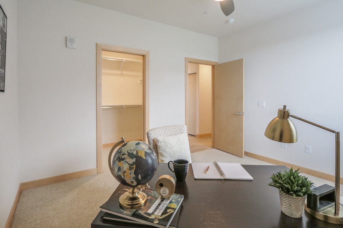 an office with a desk and a chair and a closet