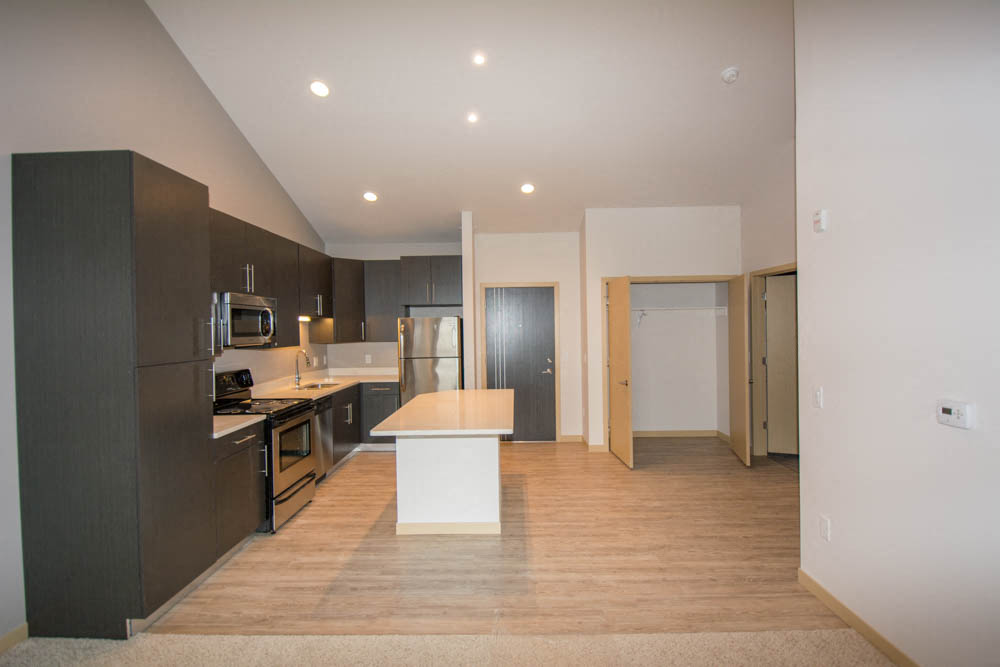 an empty kitchen with a table in the middle
