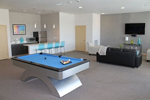 a large living room with a pool table
