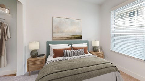 A bedroom with a large bed and a painting on the wall.