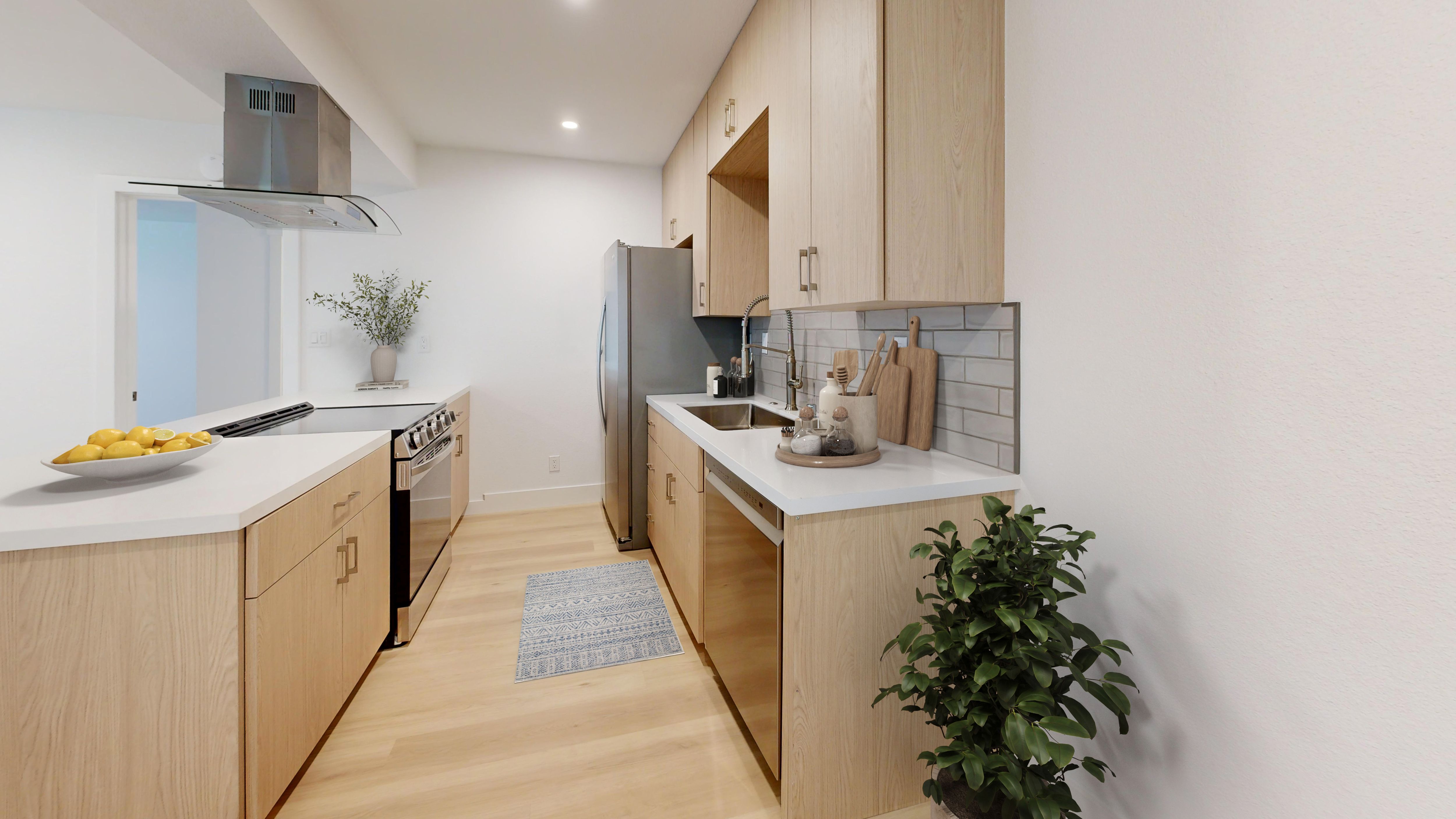 A kitchen with wooden cabinets and a black fridge.