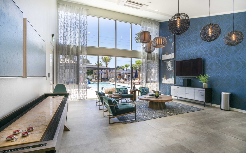 a living room with blue wallpaper and a pool in the background