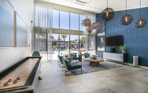 a living room with blue wallpaper and a pool in the background