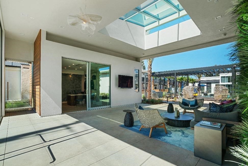 the living room has a retractable roof and a view of the city
