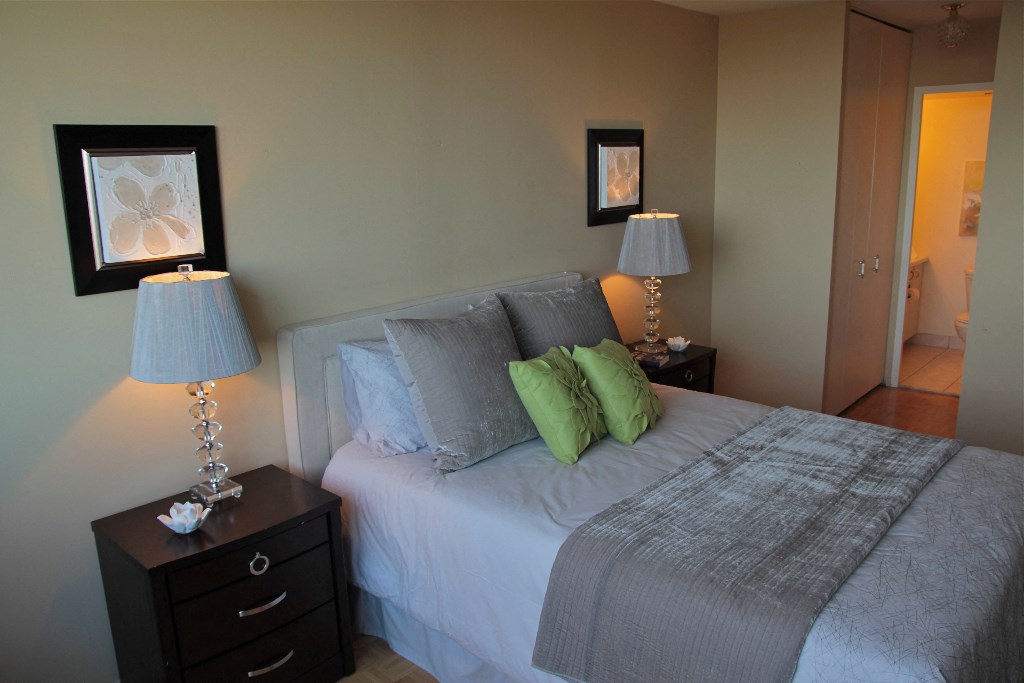 a bedroom with a bed and two lamps