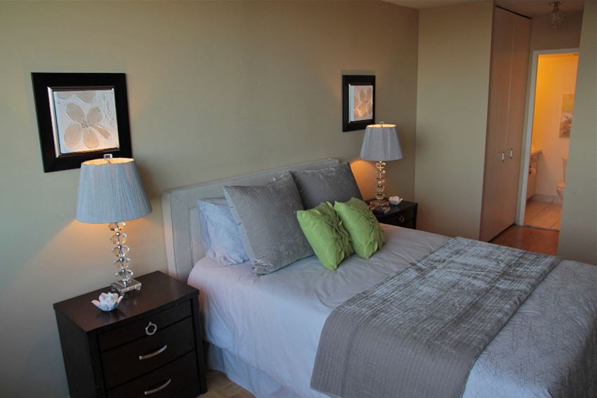 a bedroom with a bed and two lamps