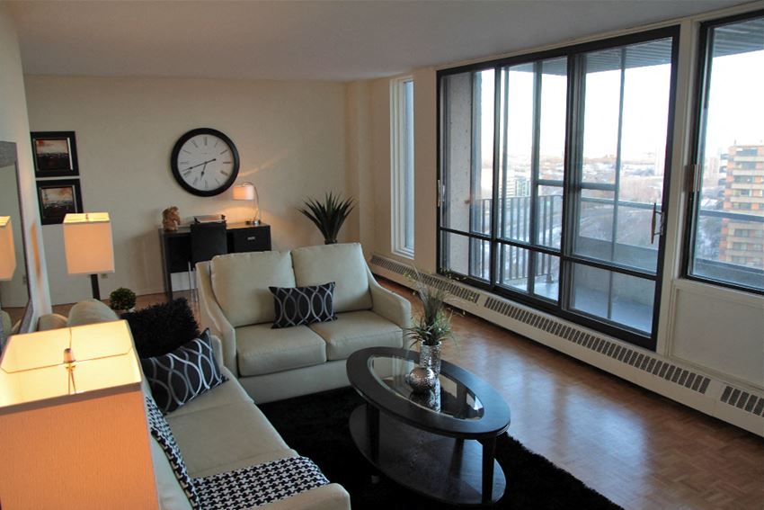 a living room with a couch and a table and a large window