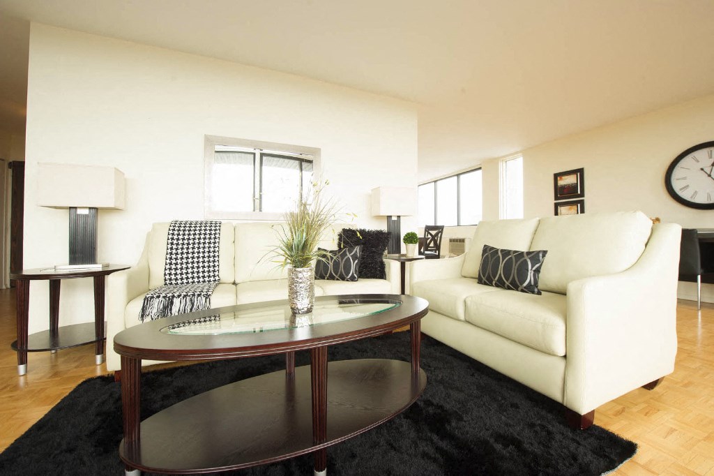 a living room with white couches and a coffee table