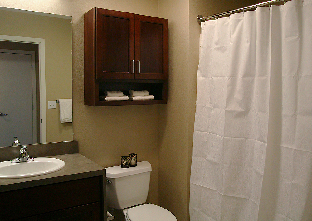 a small bathroom with a shower and toilet and a sink
