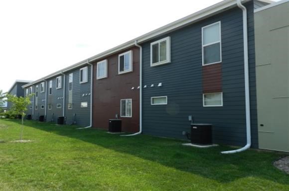a row of houses with green grass in front of them