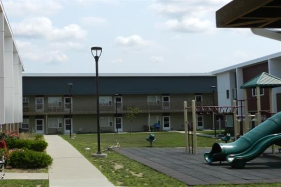 an empty playground in front of a building
