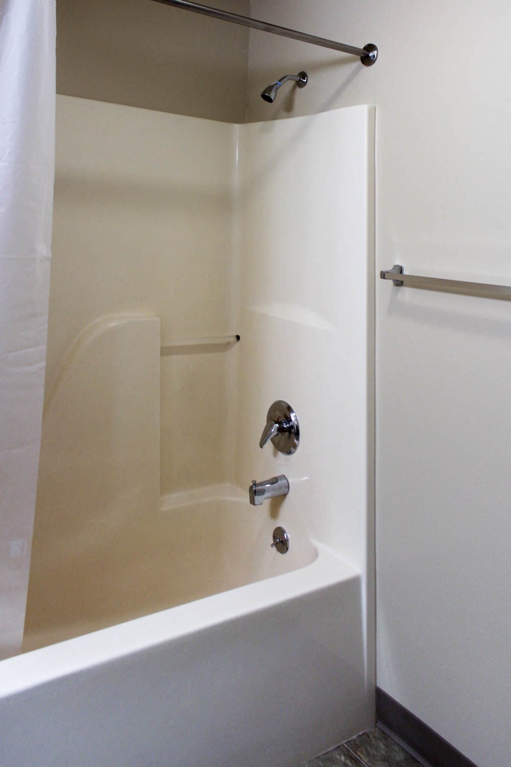 a bathroom with a tub and a shower and a curtain