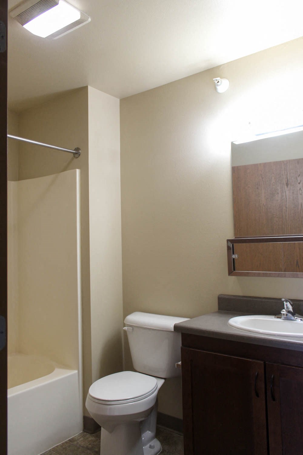 a bathroom with a toilet and a sink and a shower