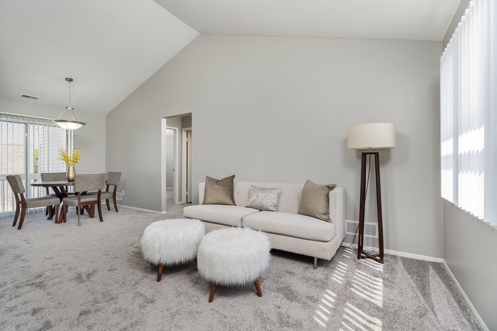 a living room with a couch and a dining room table