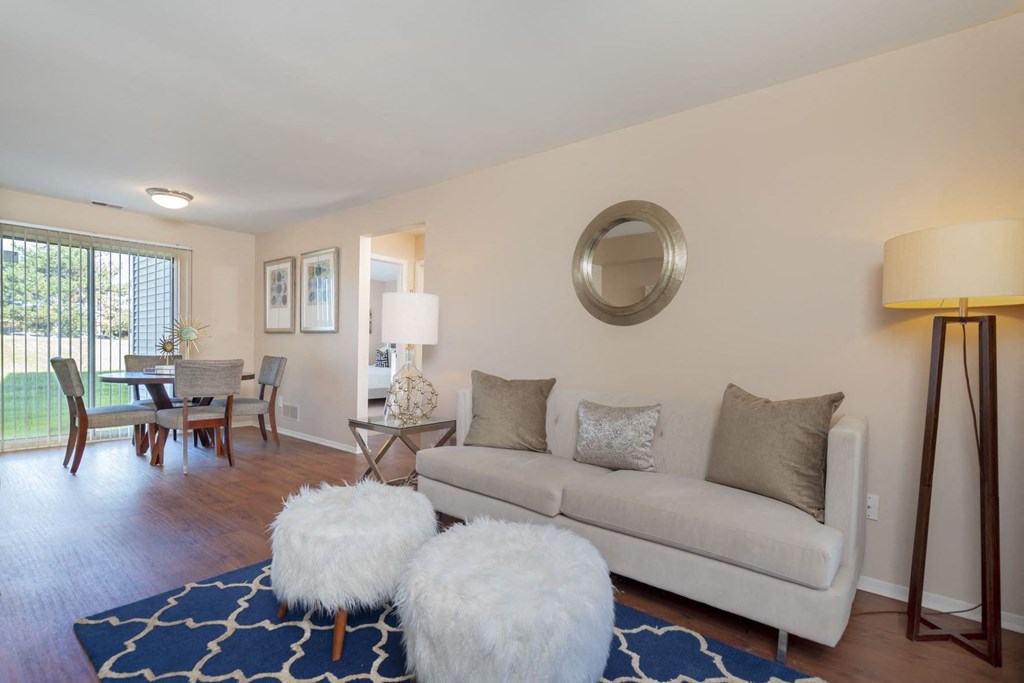 a living room with a couch and a dining room table