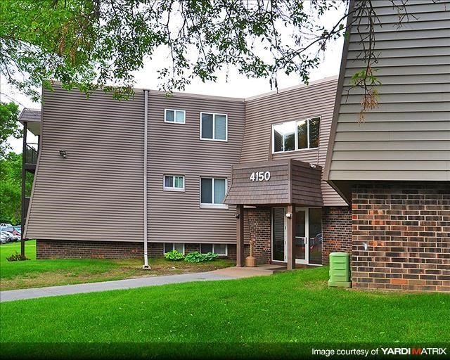 a building with a yard and grass in front of it