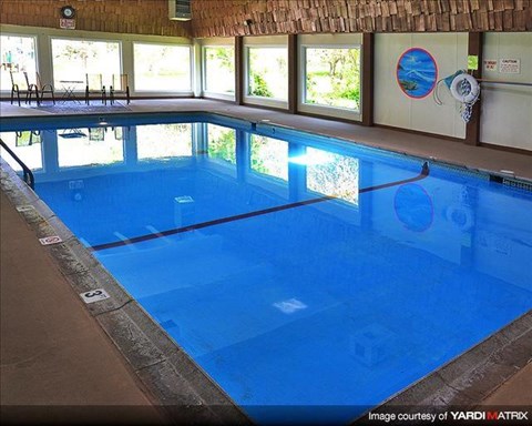 a large blue swimming pool in a building