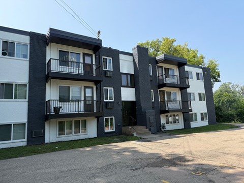 Apartment buildings with balconies and doors are shown in the image.