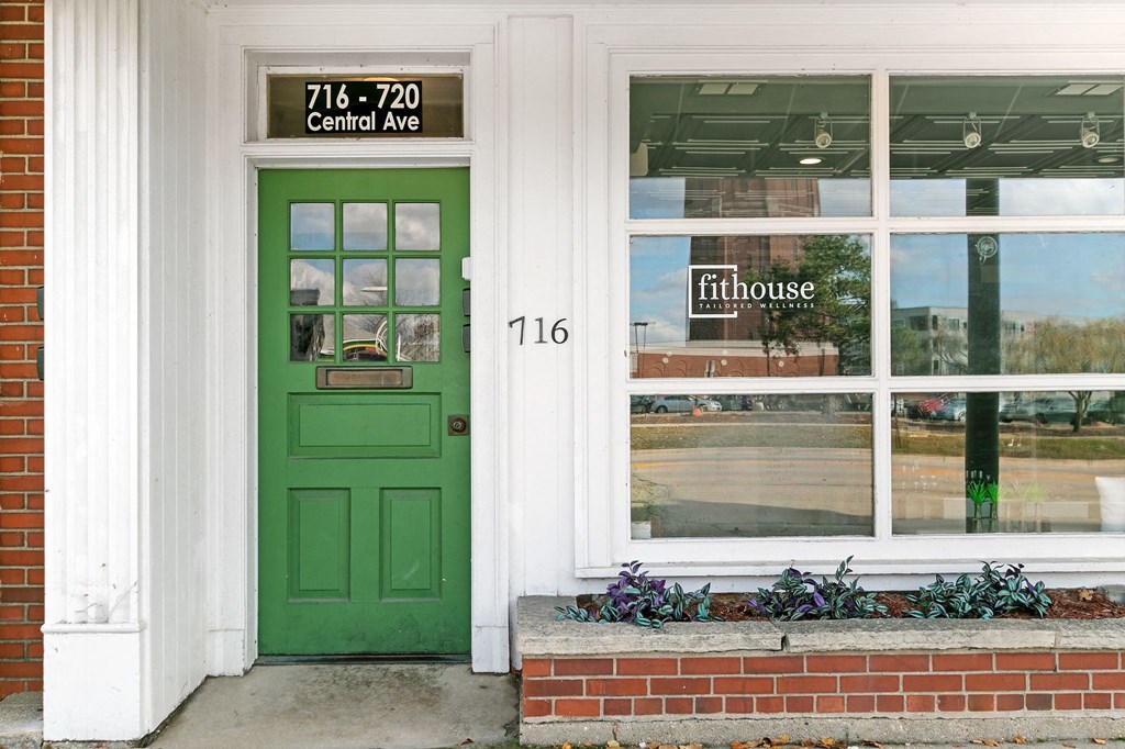a green door on the side of a building