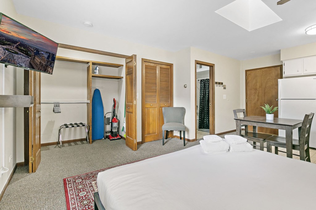 a bedroom with a bed and a table and a closet