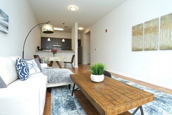 Model unit living room with view of kitchen - Photo Gallery 5
