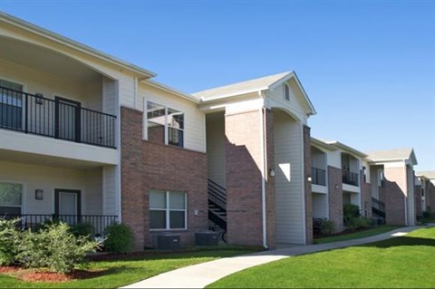 Apartment complex with a clear blue sky above.