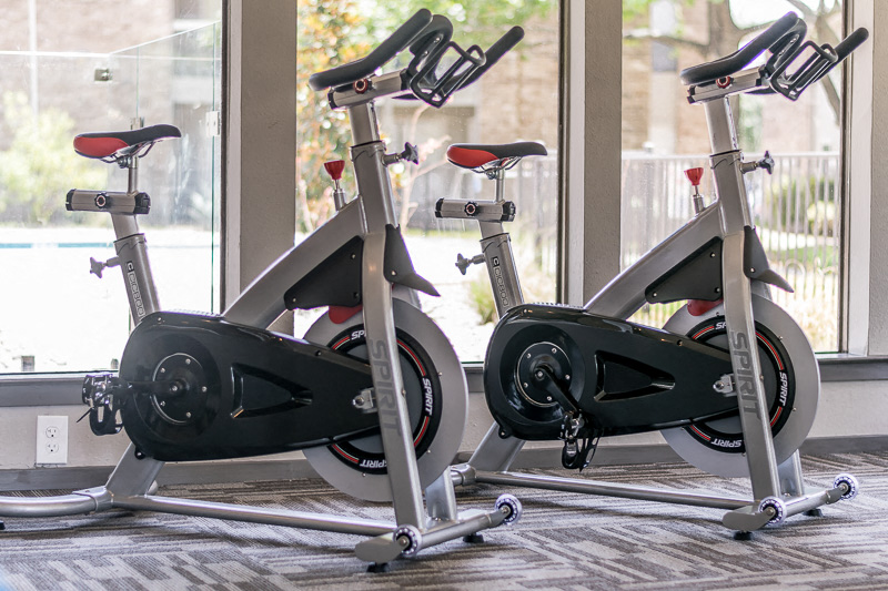 a row of exercise bikes in a gym