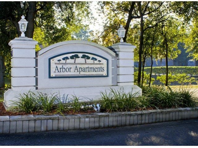 a sign for abbot apartments on the side of a road