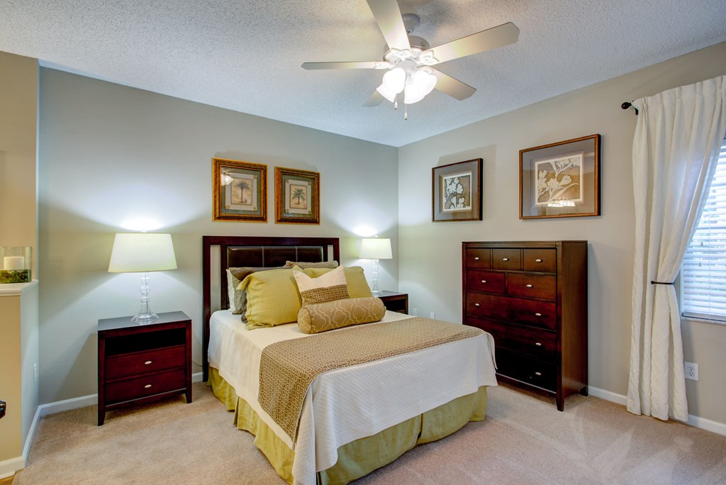 a bedroom with a bed and a ceiling fan
