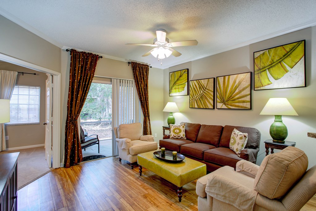 a living room with furniture and a ceiling fan