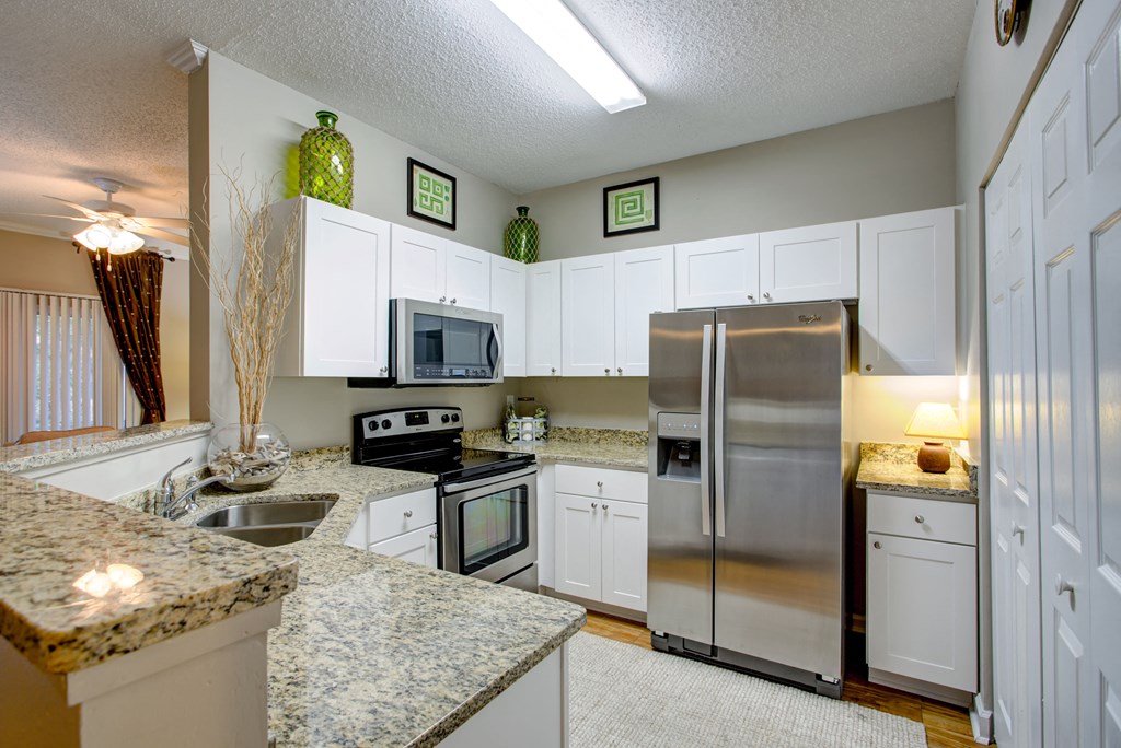a kitchen with stainless steel appliances and granite counter tops
