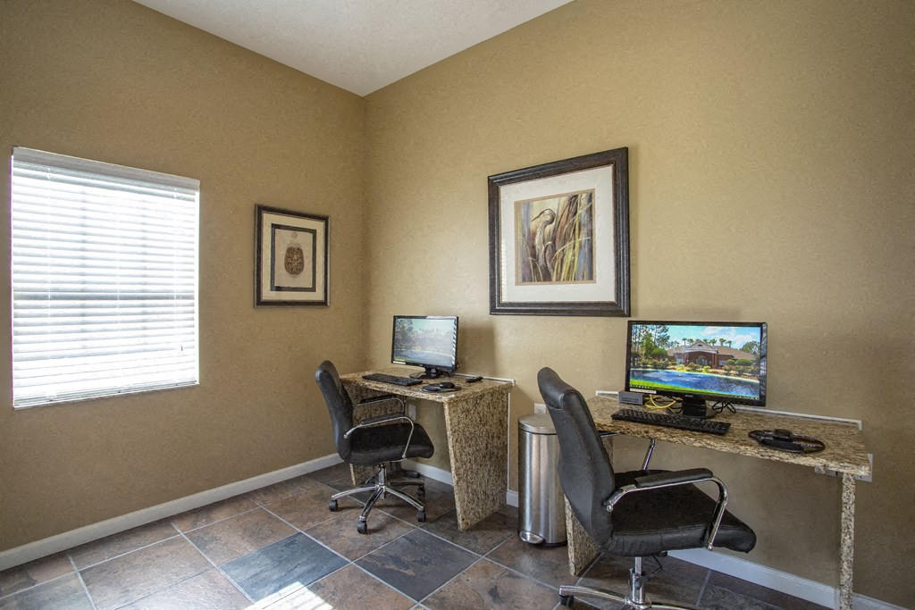 a home office with two computer monitors and a desk