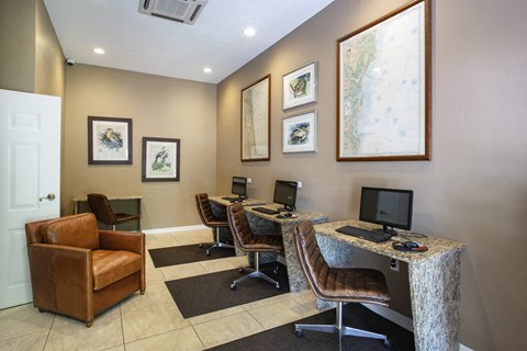 a office with two desks and chairs and two computers