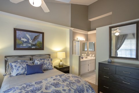 a bedroom with a bed and a bathroom