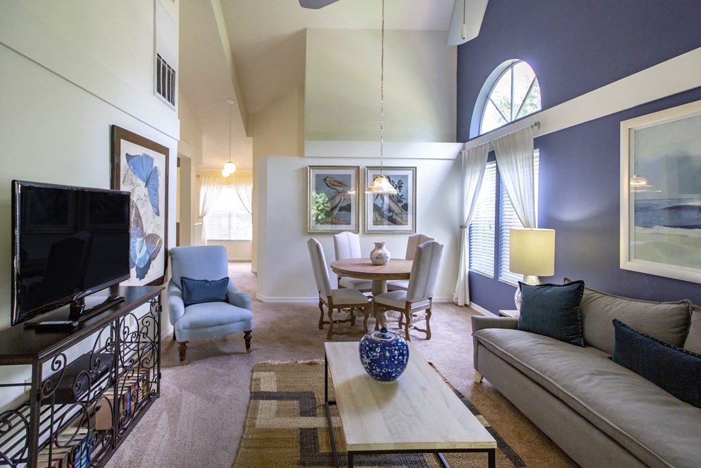 a living room with a table and a couch and a television