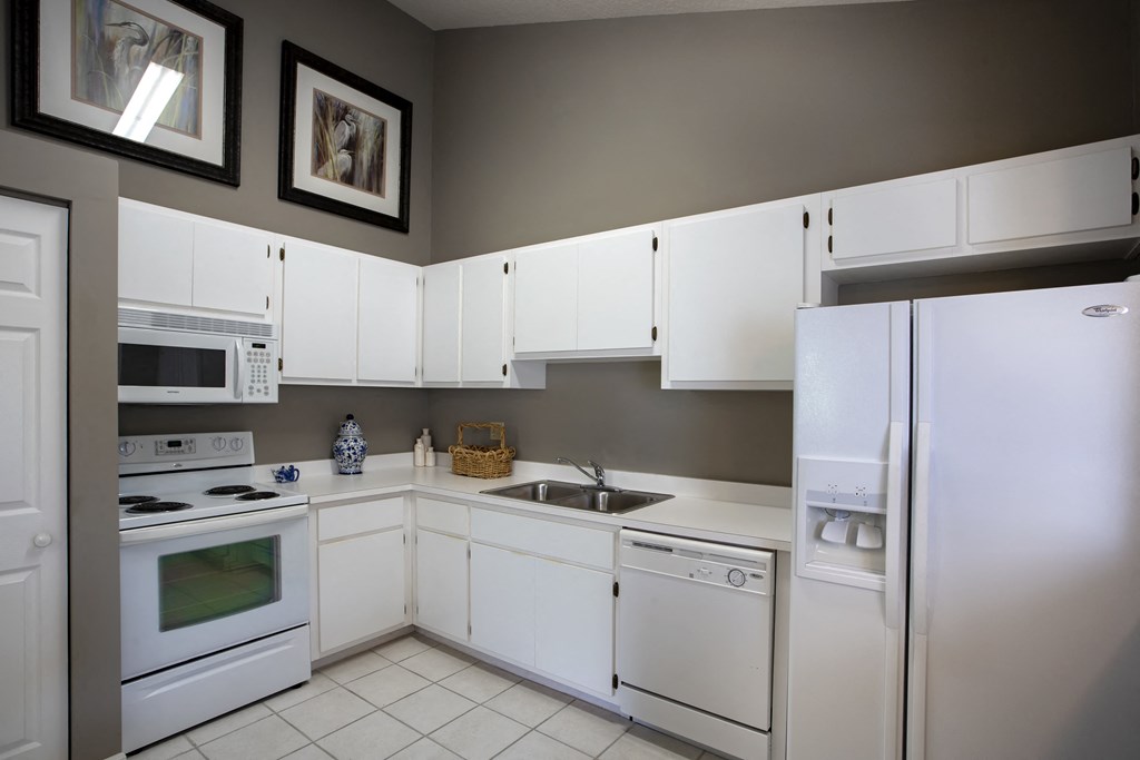 a kitchen with white appliances and white cabinets