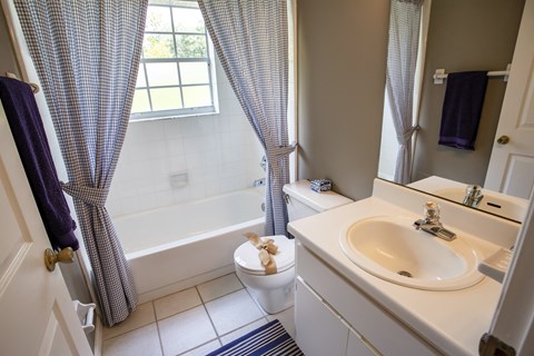 an image of a bathroom with a sink toilet and tub
