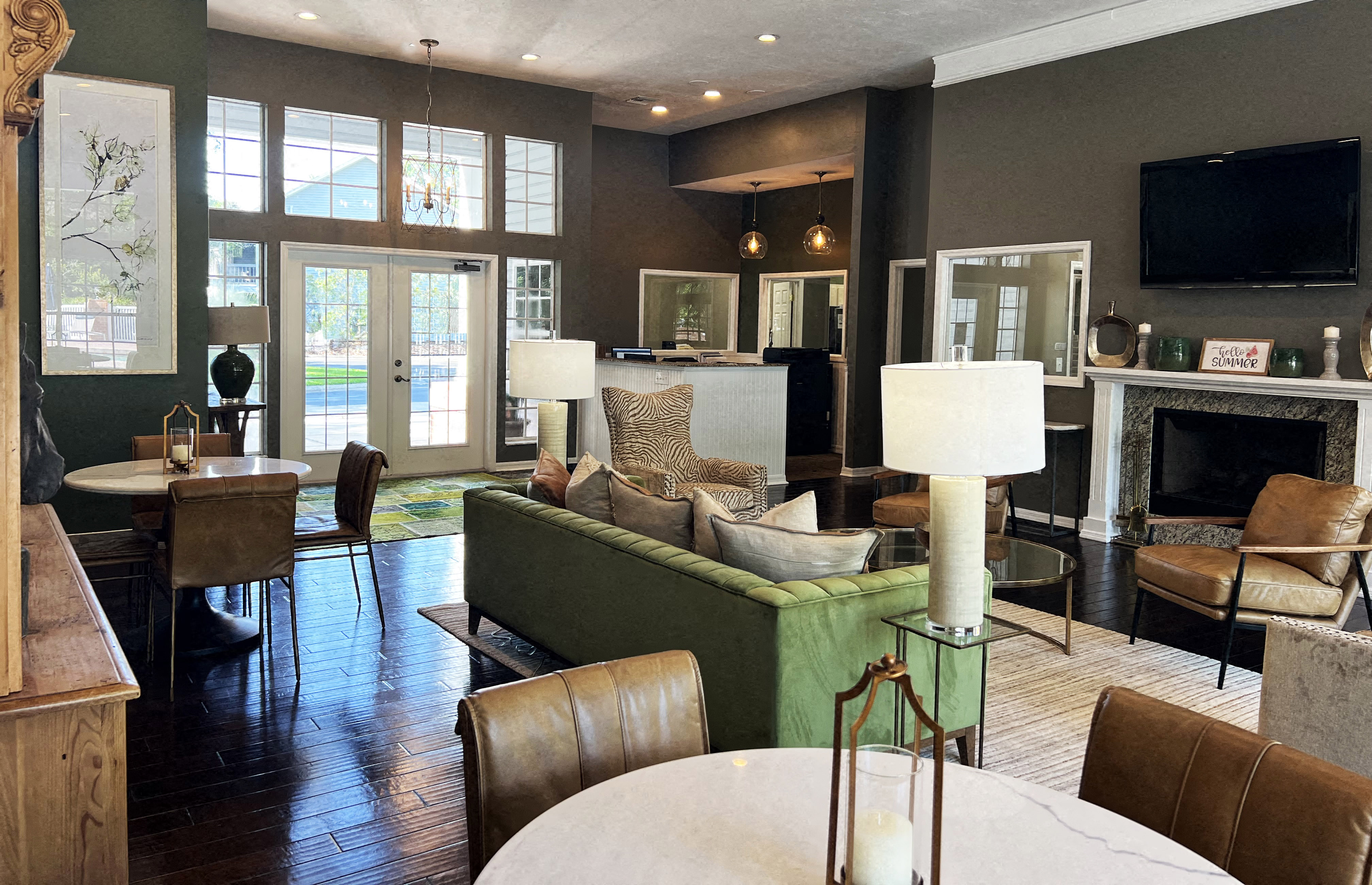 a living room with a table and chairs and a fireplace