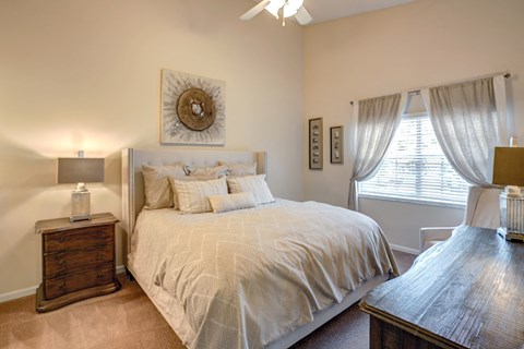 a bedroom with a large bed and a window