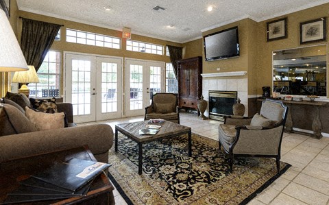 a living room with couches and chairs and a fireplace