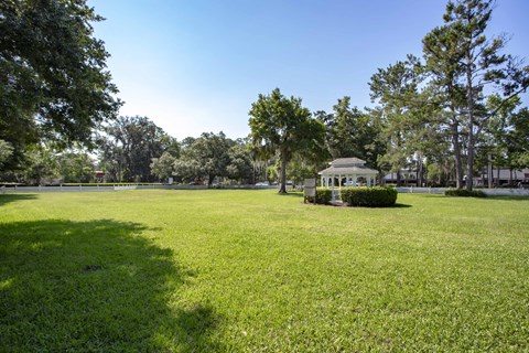 a park with a gazebo in the middle of a field