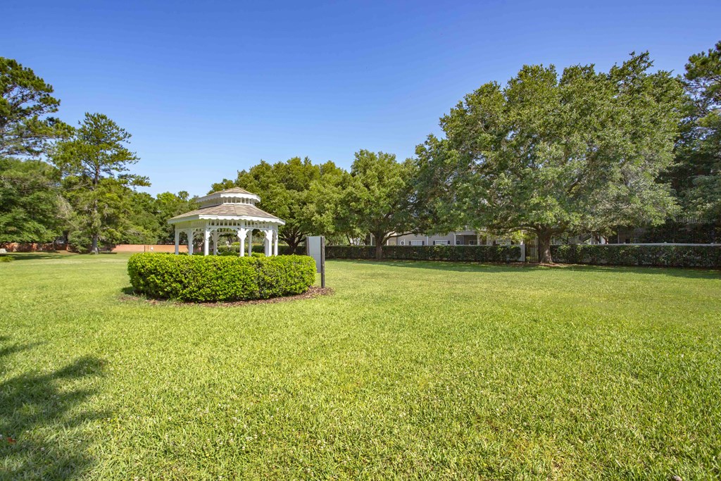 a park with a gazebo in the middle of a field