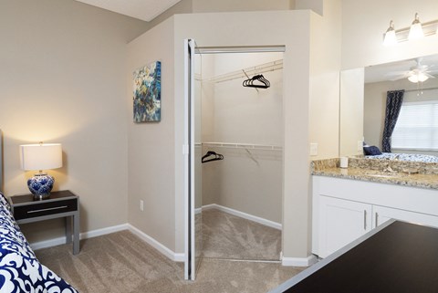 an open bathroom with a shower and a sink in a room with a bed