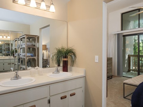 a bathroom with two sinks and a large mirror