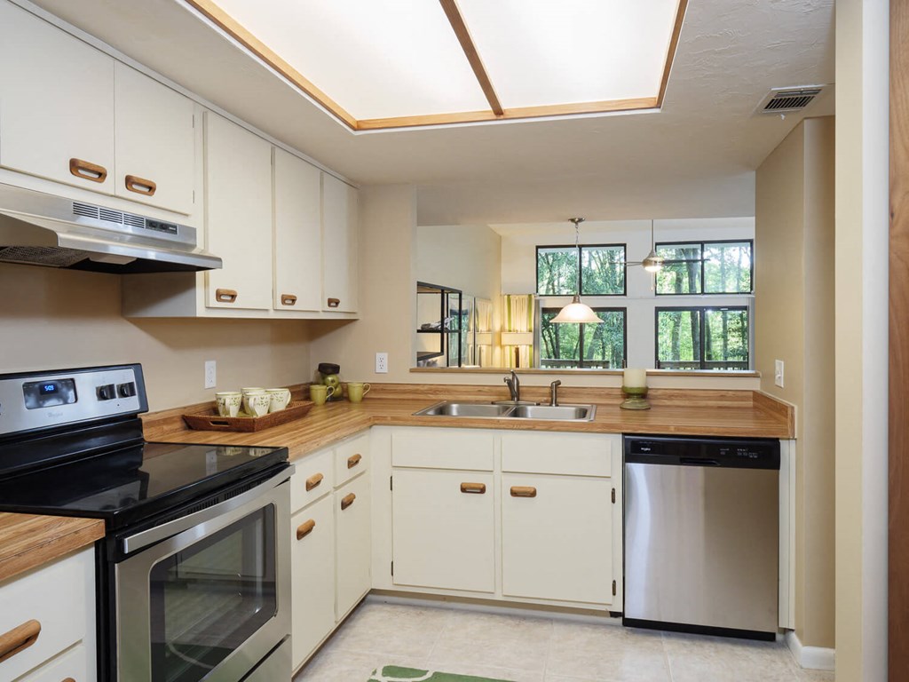a kitchen with white cabinets and a sink and a stove