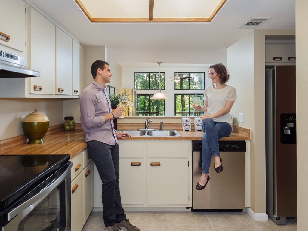 a man and a woman in a kitchen talking