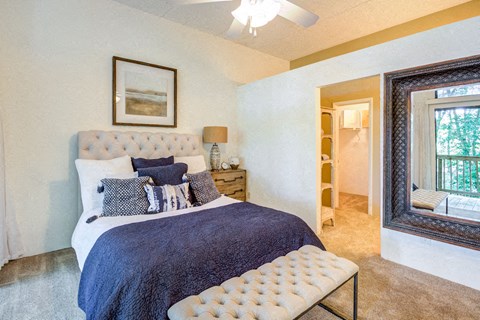 a bedroom with a bed and a mirror